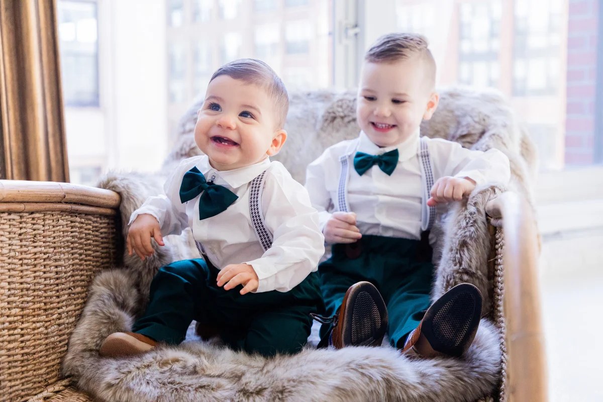 Two smiling brothers in matching green bow ties at a Chicago holiday mini session